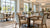 Sunlit senior living dining room with upholstered armchairs and dining tables