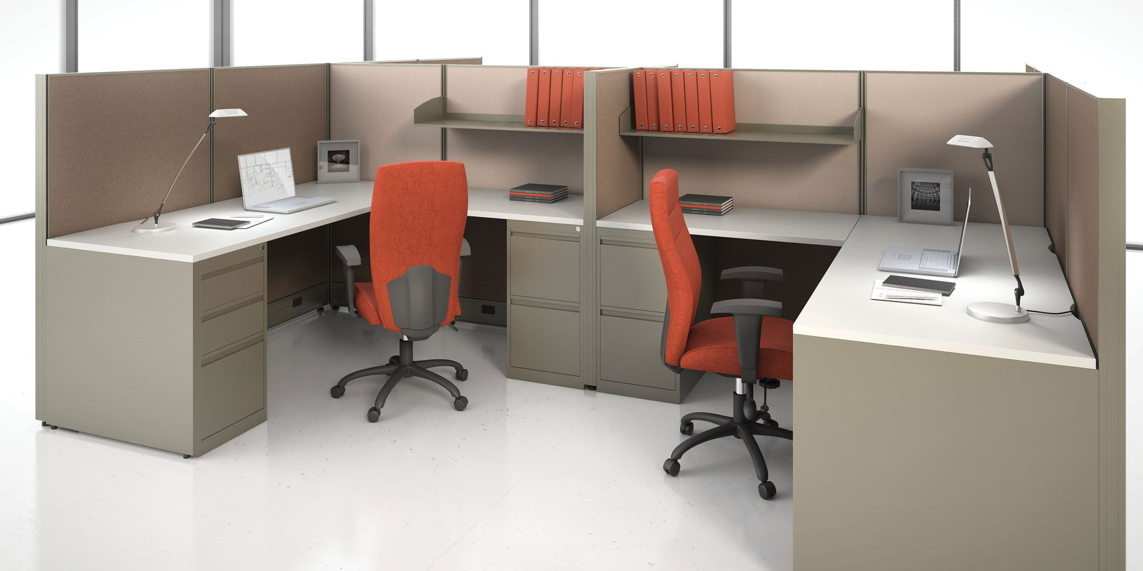 Modern office cubicles with orange chairs and white desks.