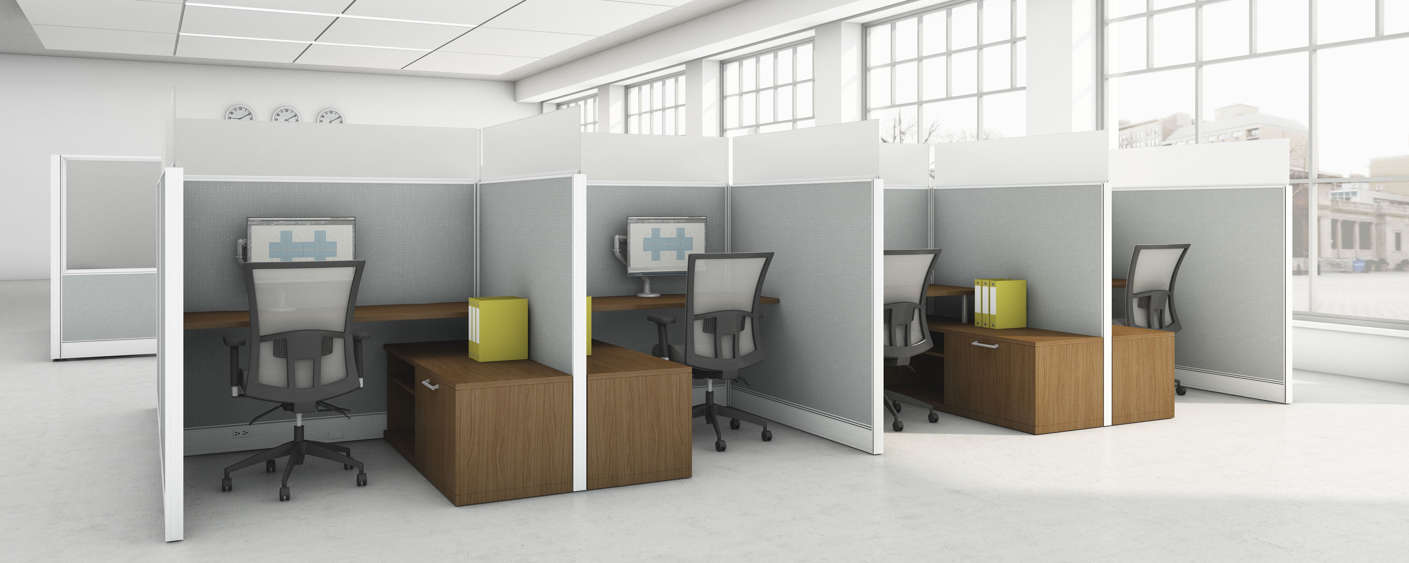 Modern office setup with wooden desks and chairs in a bright room.