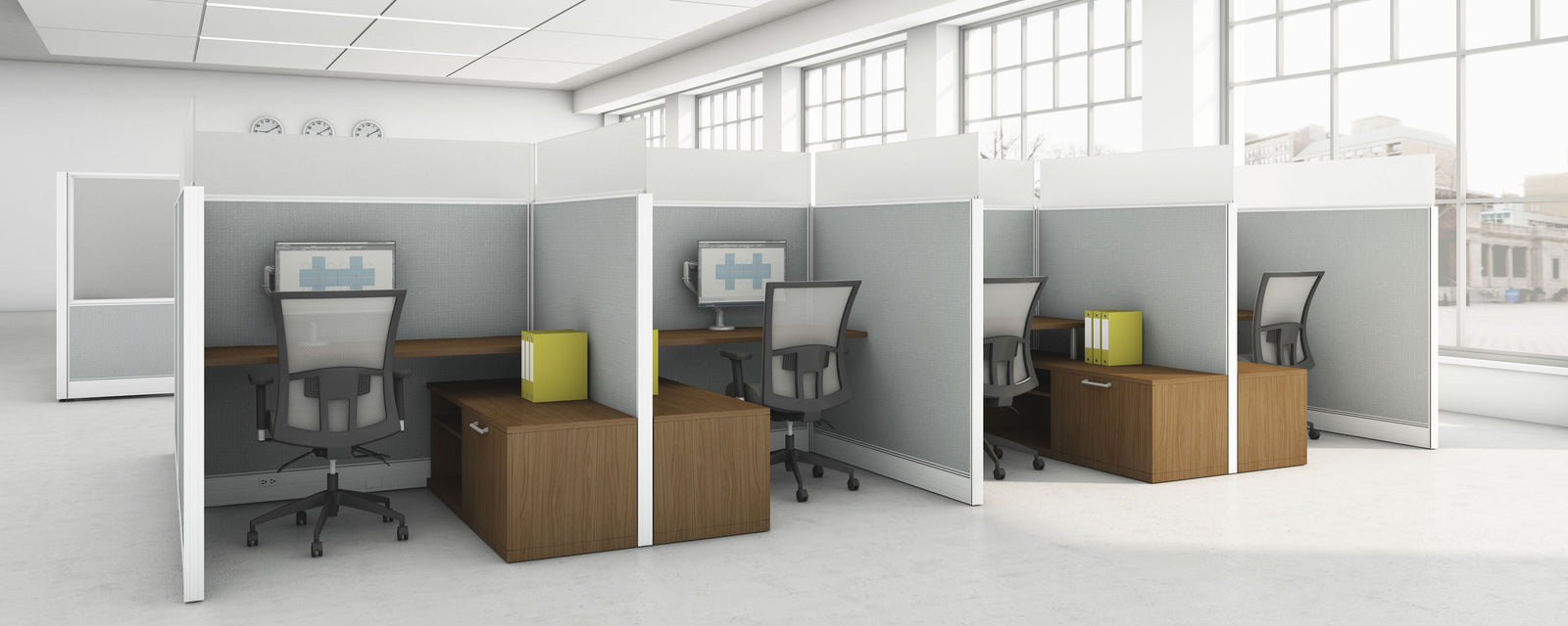 Modern office setup with wooden desks and chairs in a bright room.