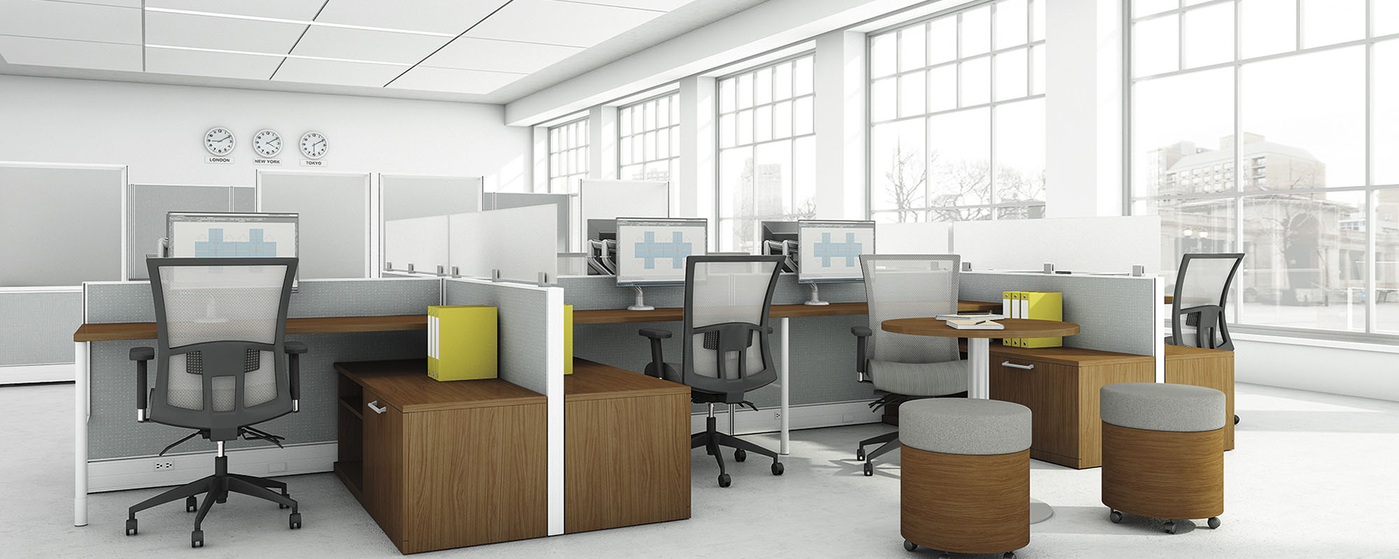 Modern office setup with desks, chairs, and cubicles in a bright room.