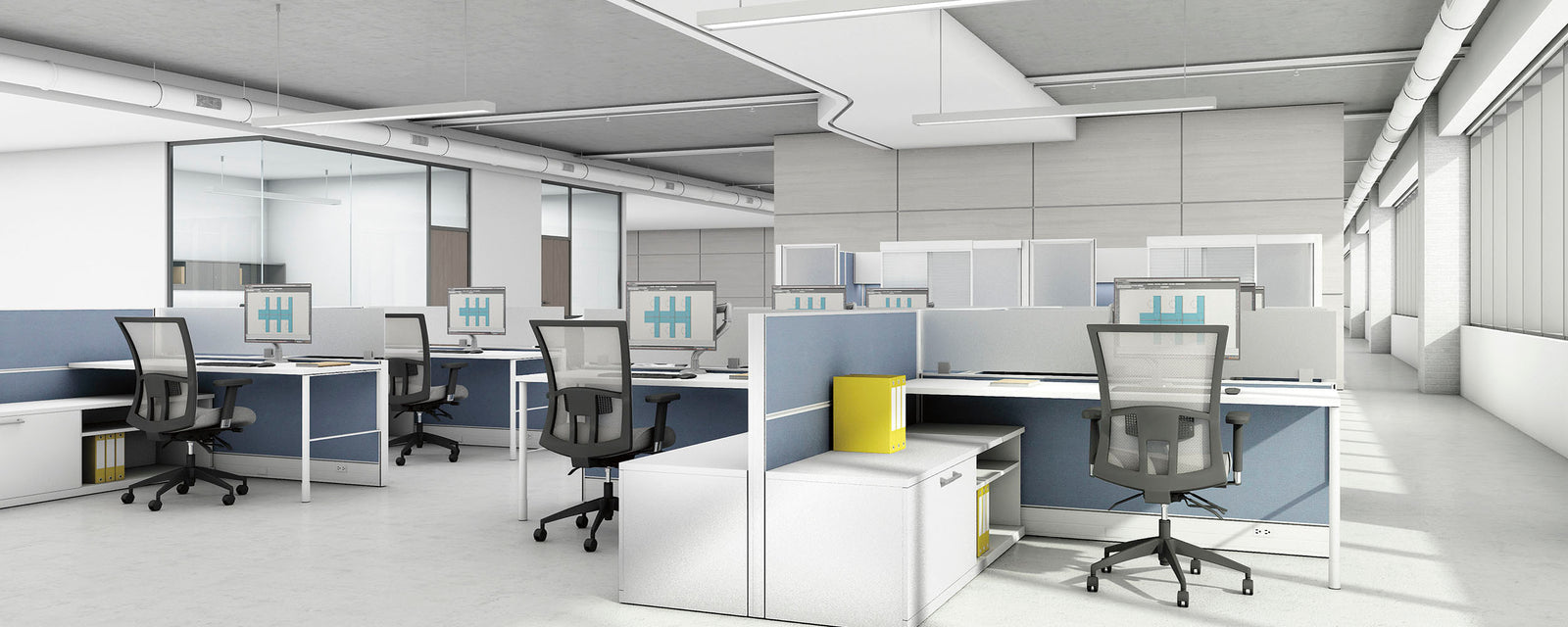 Modern office layout with desks, chairs, and partitions.