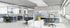 Modern office layout with desks, chairs, and partitions.