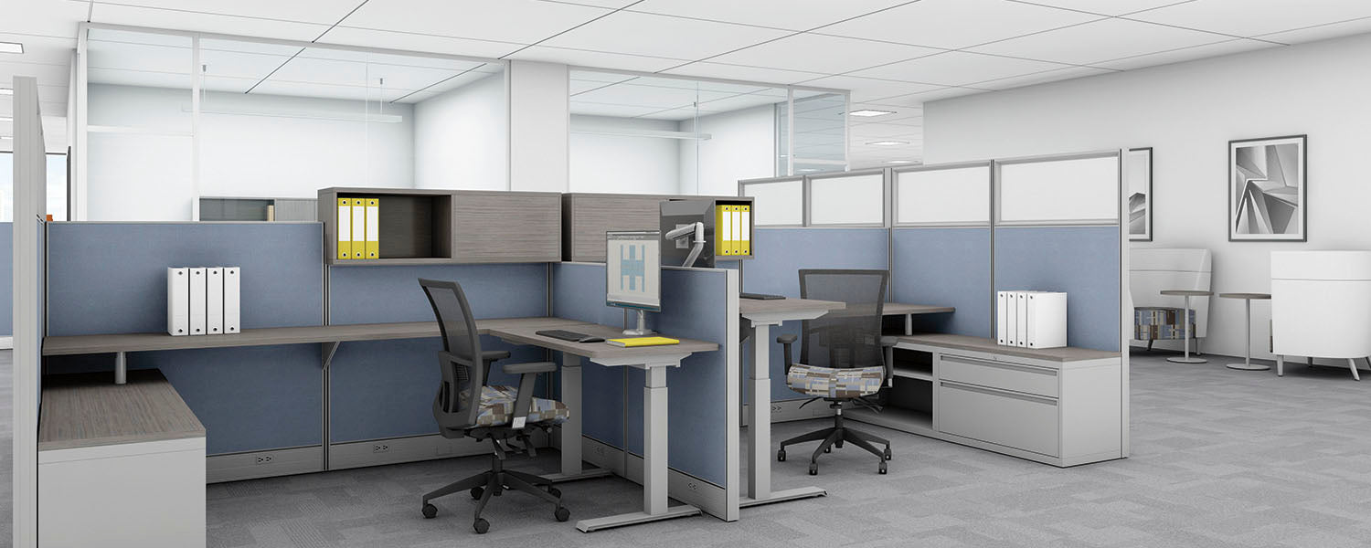 Modern office layout with desks and partitions in a well-lit room.