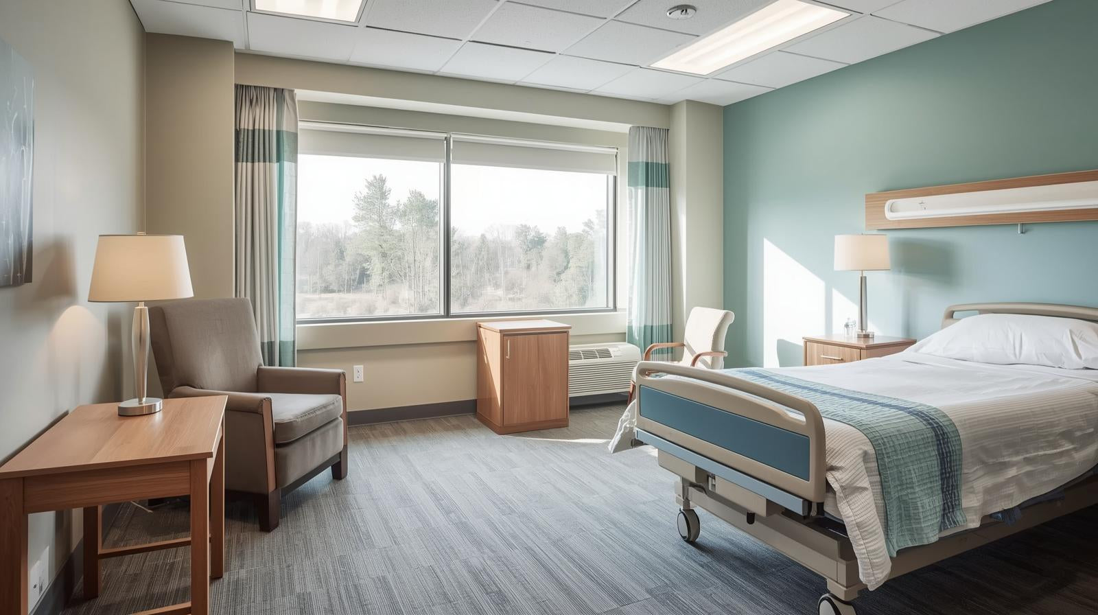 Hospital room with bed, chair, and large window